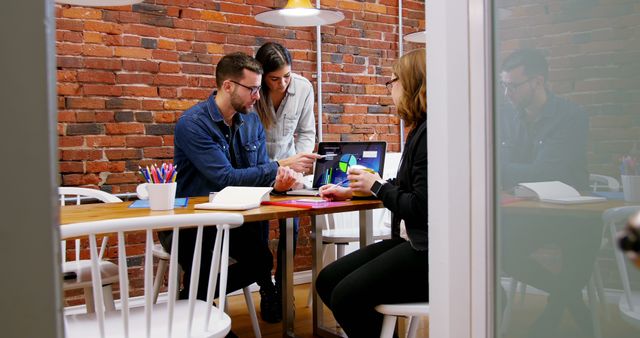 Collaborative Team Meeting in Modern Office Space with Brick Wall - Download Free Stock Images Pikwizard.com