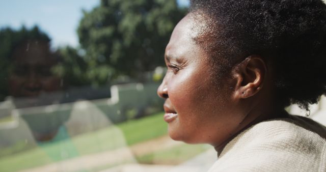 Thoughtful Woman Gazing Through Window on Sunny Day - Download Free Stock Images Pikwizard.com