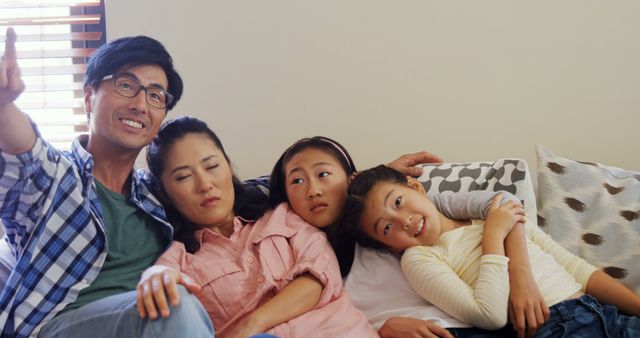Happy Asian Family Relaxing Together on Sofa in Living Room - Download Free Stock Images Pikwizard.com