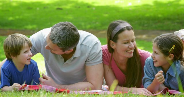 Happy Family Lying on Grass and Enjoying Outdoor Picnic - Download Free Stock Images Pikwizard.com