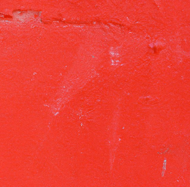 Bright red background with abstract texture serves as versatile visual content for graphic design, marketing materials, or as a backdrop for text. Its bold color and distressed texture add a striking element to creative projects including posters, websites, and branding elements.