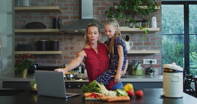 Busy Mother Balancing Work and Child in Modern Kitchen - Download Free Stock Images Pikwizard.com