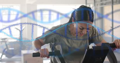 Caucasian Woman Training on Elliptical with DNA Strand Digital Overlay
