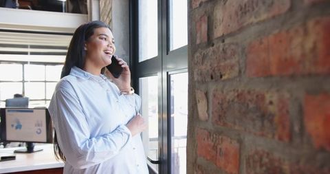 Pregnant Woman in Modern Office Speaking on Smartphone