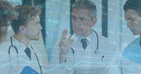 Doctors engaged in discussing digital health data, emphasizing team collaboration and innovative hospital practices. Useful for topics on healthcare teamwork, medical analysis, and technology in medicine.