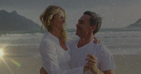 Senior couple sharing romantic moment on tranquil beach