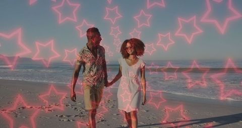 Joyful Romantic Couple Strolling Along Beach with Neon Stars