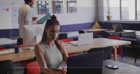 Focused young professional working in collaborative office environment