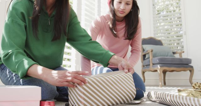 Mother and Daughter Wrapping Christmas Gift at Home - Download Free Stock Images Pikwizard.com