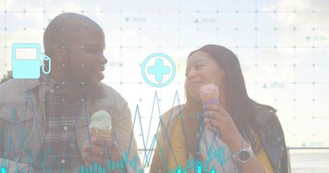 Couple enjoying ice cream by waterfront with digital data charts overlay