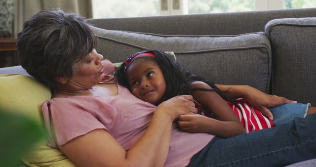 Grandmother and Granddaughter Relaxing Together on Sofa - Download Free Stock Images Pikwizard.com