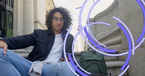 Young man relaxing with smartphone outdoors amid autumn