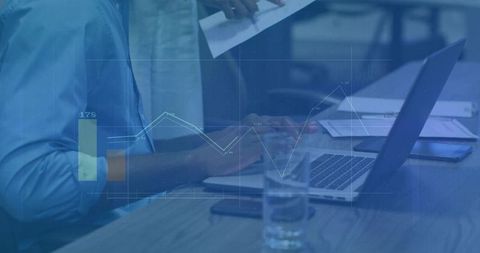 Business Analysts Reviewing Financial Data in Modern Office Environment