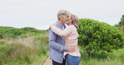 Senior Couple Embracing on Nature Path Outdoors