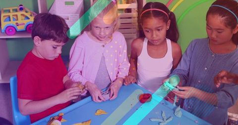 Children molding playdough at colorful classroom activity table