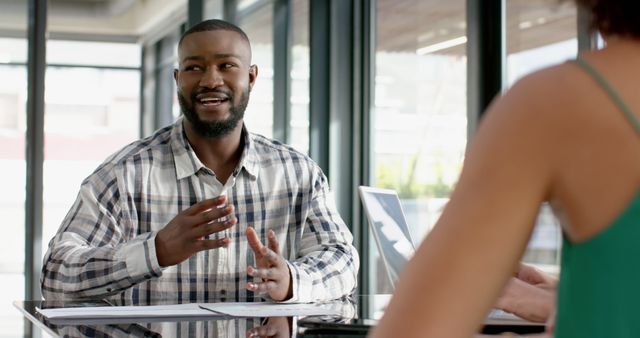 Confident man discussing at business meeting in modern office - Download Free Stock Images Pikwizard.com