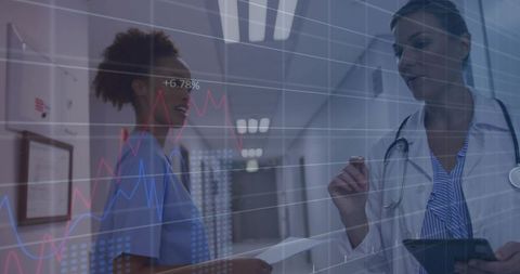 Clinicians Collaborating and Reviewing Digital Health Analytics in Hospital Corridor