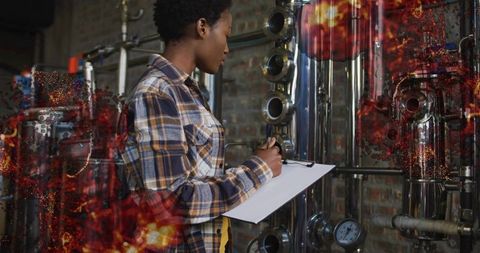 Technician monitoring pressure gauges in manufacturing plant