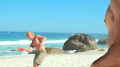 Friends Enjoying Frisbee on Sunny Beach
