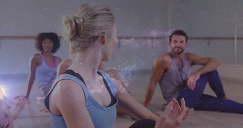 Group yoga class meditating with starry overlay conveying mindfulness and balance