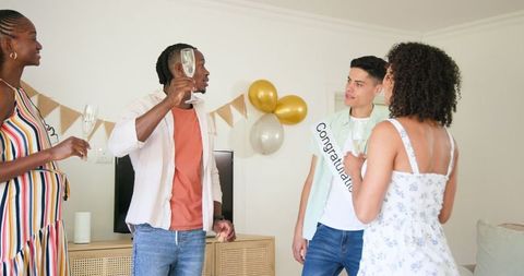 Friends Celebrating with Champagne Toast and Decorations