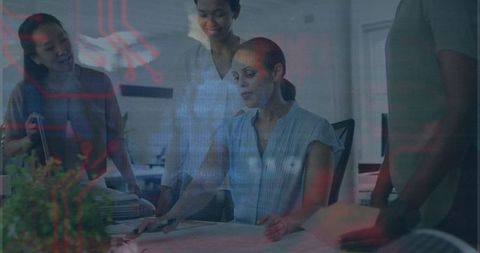 Confident Women Collaborating Over Innovative Blueprints in Office