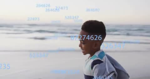 Young Boy Running at Beach with Digital Data Display Overlay