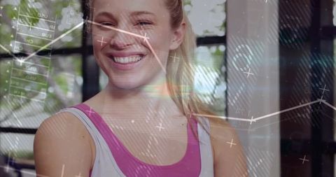 Smiling Woman in Fitness Wear Surrounded by Digital Metrics Overlay