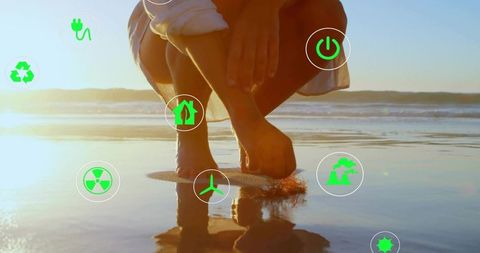 Eco living at beach shoreline with renewable icons