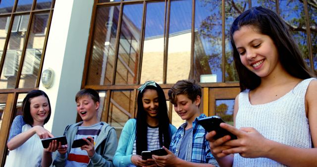 Teenagers Socializing and Using Smartphones Outdoors - Download Free Stock Images Pikwizard.com