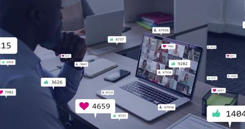 Senior professional monitoring virtual team meeting with live reaction badges on laptop