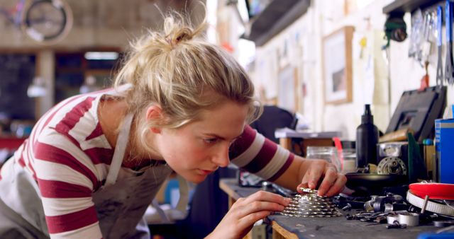 Focused Female Mechanic Assembling Bicycle Gear Components at Workshop - Download Free Stock Images Pikwizard.com