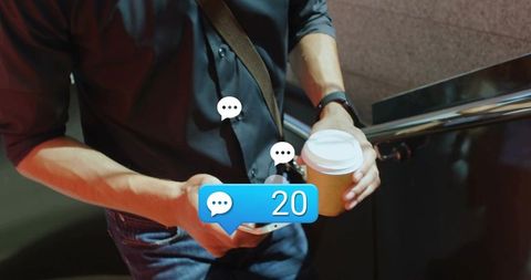 Checking smartphone while holding takeaway coffee with 20 chat notifications at stairwell