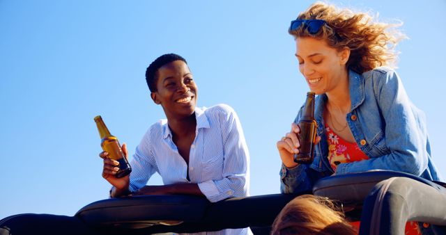 Happy friends enjoying drinks outdoors under blue sky - Download Free Stock Images Pikwizard.com