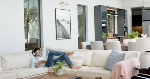 Man Relaxing with Headphones in Open-Plan Living Room