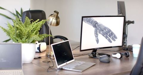 Futuristic office with robotic hand on display