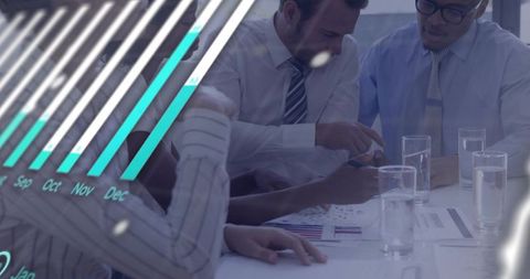 Business team reviewing monthly charts and documents with teal overlay and collaboration