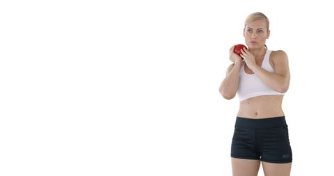 Focused Fitness Enthusiast Holding Red Apple