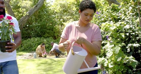Diverse Friends Enjoying Gardening in Lush Greenery