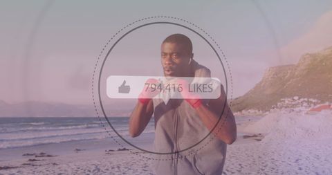 African american boxer training on beach with social media likes