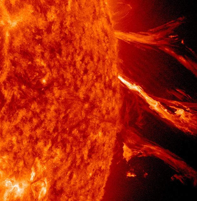 Solar flare and coronal mass ejection captured by NASA on January 2, 2012. Dramatic view of the Sun in extreme ultraviolet light, showing large solar eruptions and particle clouds falling back due to magnetic fields. Useful for educational content on solar activities, astronomy studies, or scientific publications about space weather.