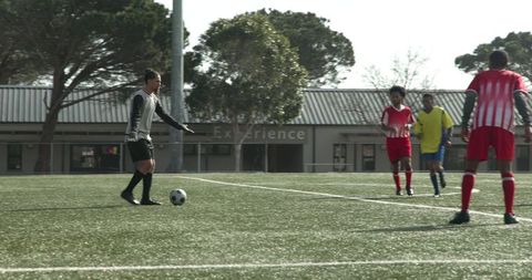 Soccer Players Practicing on Field in Colorful Jerseys