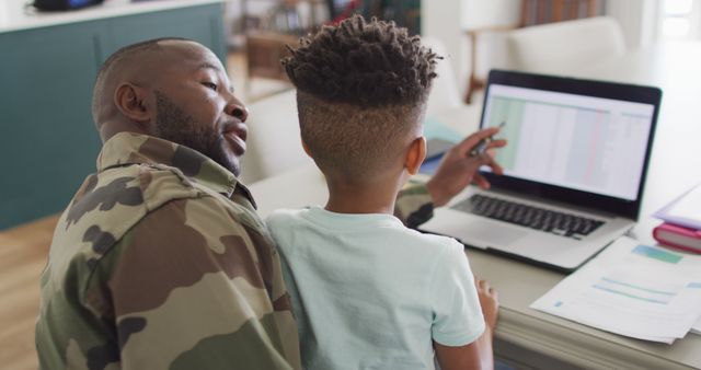 African american father with son learning together with laptop - Download Free Stock Photos Pikwizard.com
