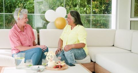 Senior Lesbian Couple Celebrating Together in Outdoor Lounge