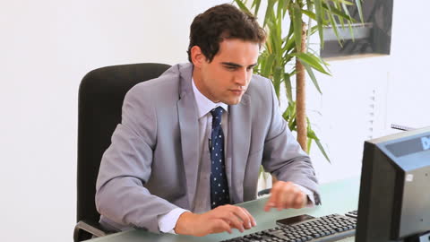 Frustrated Businessman at Office Desk in Corporate Environment