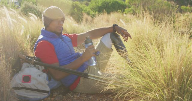 Young Man Hydrating During Outdoor Hike in Rural Landscape - Download Free Stock Images Pikwizard.com