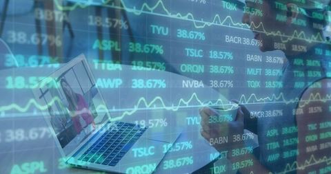Woman Writing at Desk with Overlaid Charts and Laptop