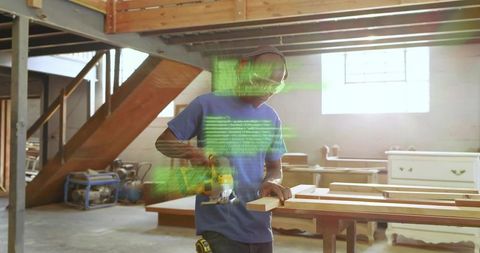 Woodworker Using Power Planer with Augmented Reality Code Overlay in Industrial Workshop