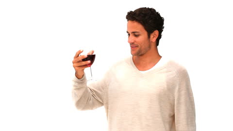 Casual Man Enjoying a Glass of Red Wine Against White Background