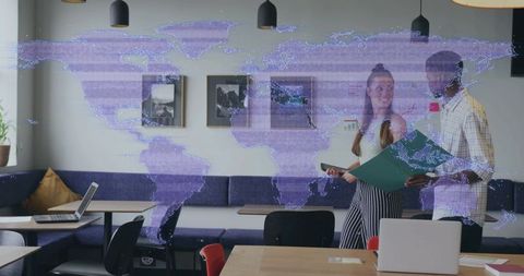 Young professionals collaborating in modern coworking space with digital world map overlay